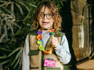 Zoo Crew - Fin in Chimpanzee Eden holding lanyard with all badges