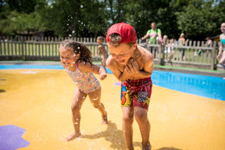 Boy and girl running through Wet 'n' Wild - July 2018