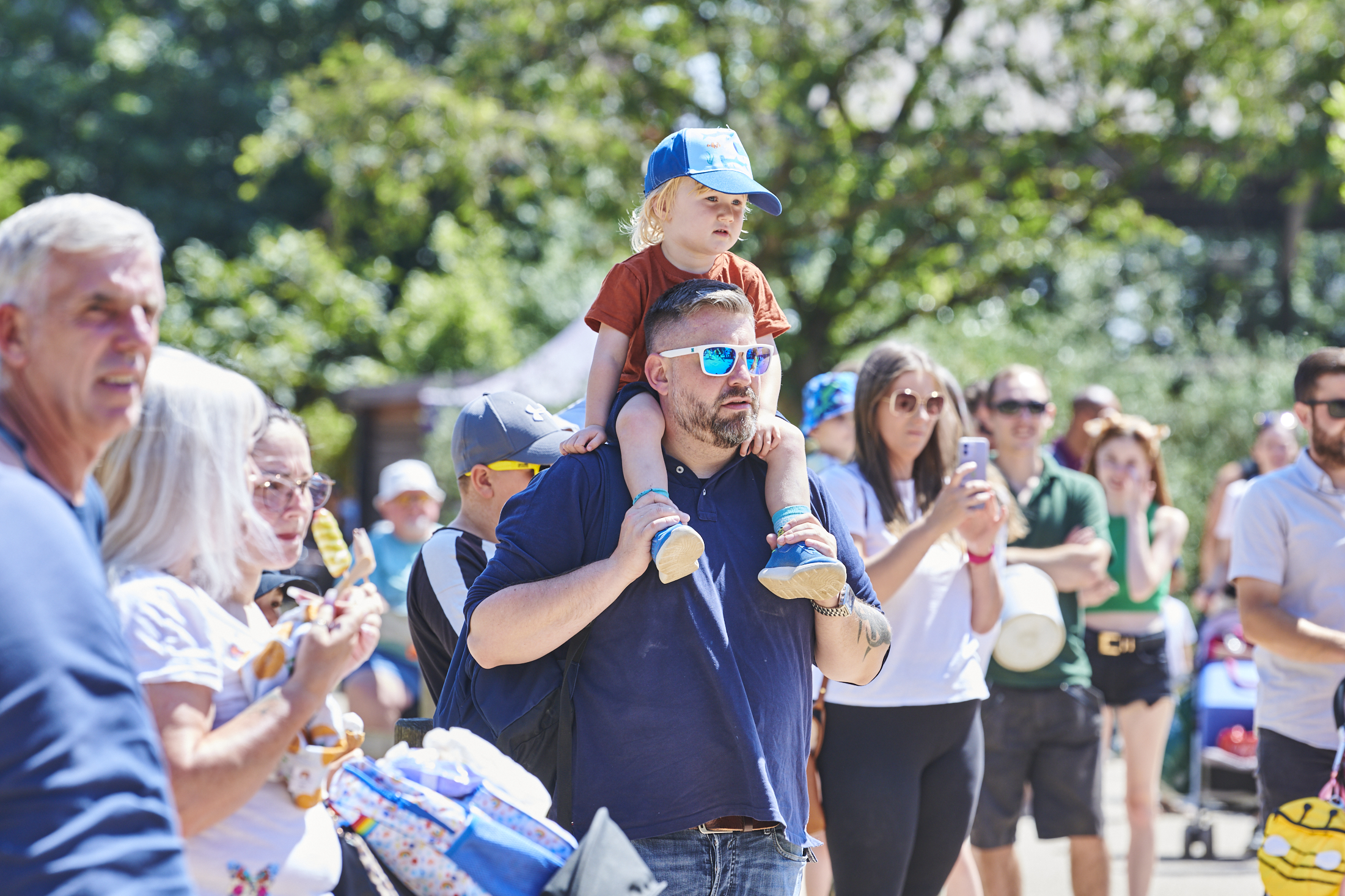 Dad with child on shoulders in crowd